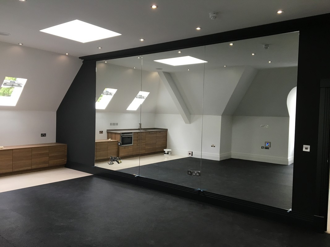 Frameless glass wall dividing loft conversion in Clerkenwell