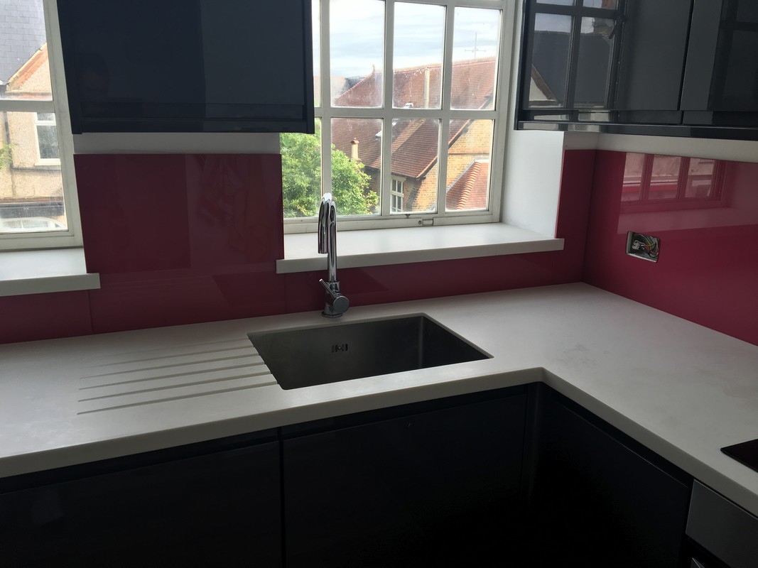Deep plum coloured glass splashback in modern Clerkenwell kitchen