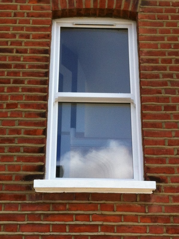 uPVC sash window on Victorian red brick house in Clerkenwell